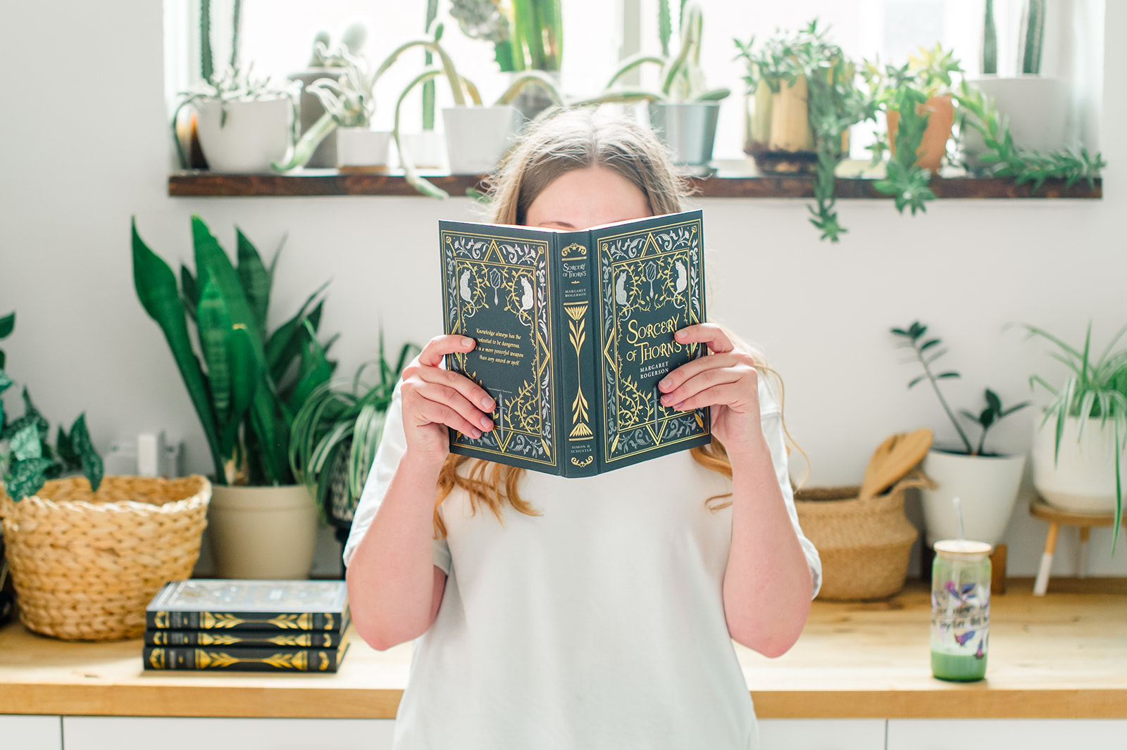 a woman holding a book over her face